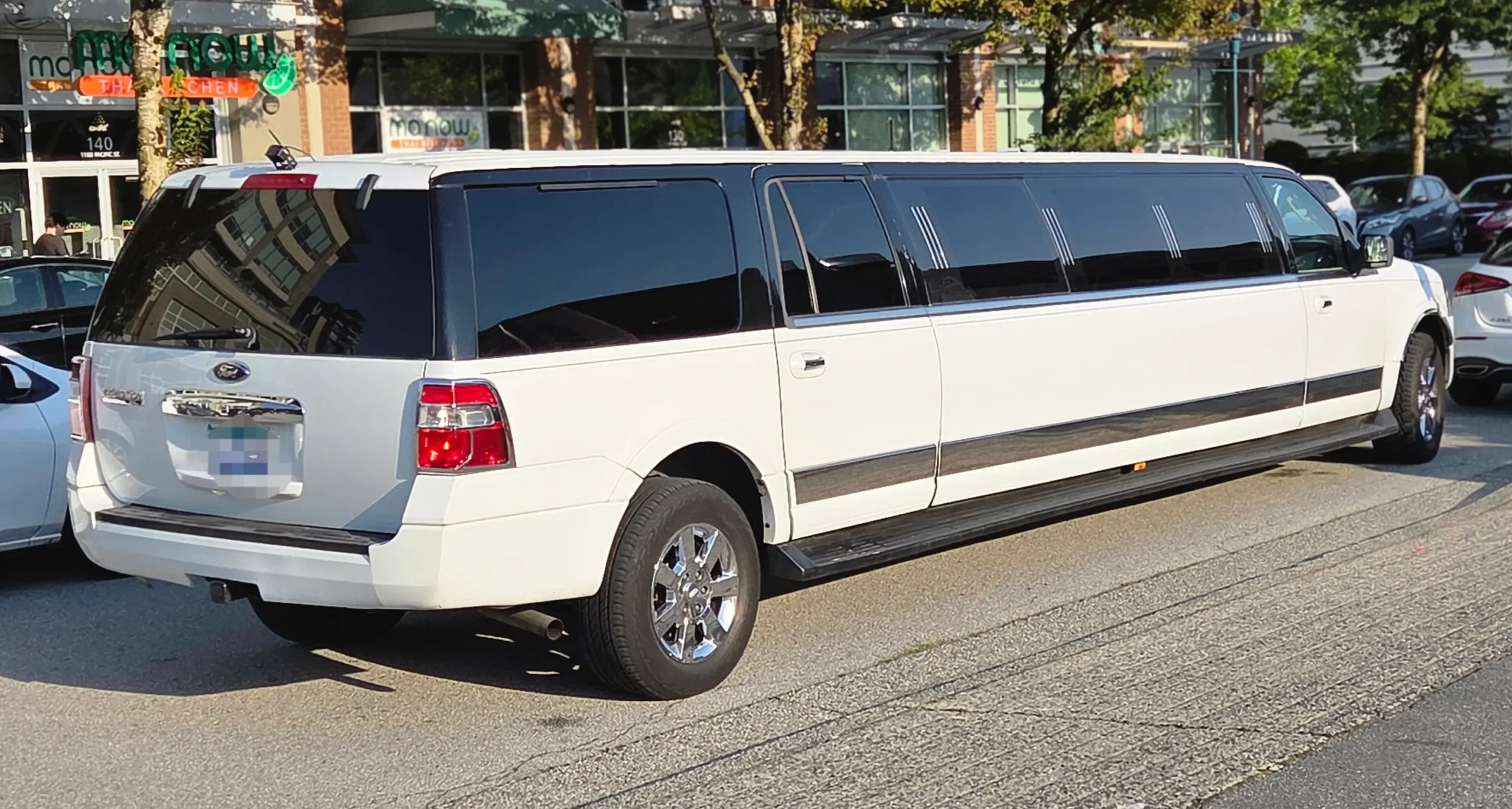 Rear view of white Ford stretch SUV party limo for 12 passengers in Vancouver